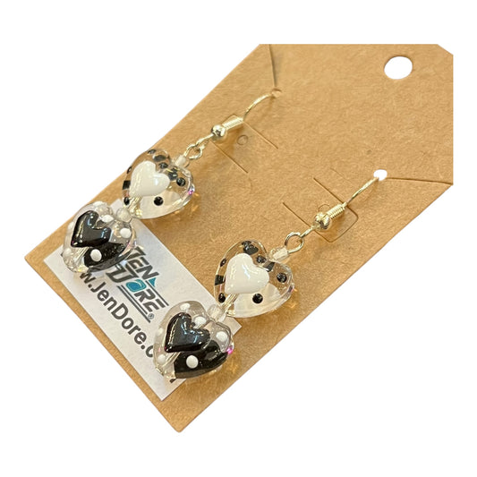 Heart-shaped earrings on a brown card with a visible brand label.