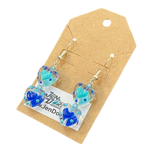 Blue heart-shaped earrings on a brown card with JenDore branding.
