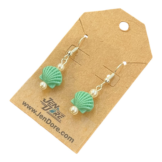 Green shell-shaped earrings with pearl beads on a JenDore branded card.
