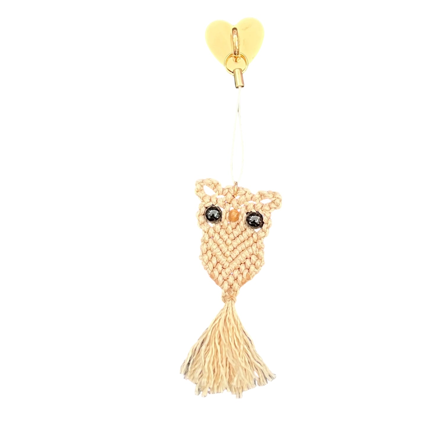 Decorative owl ornament with tassel on a white background