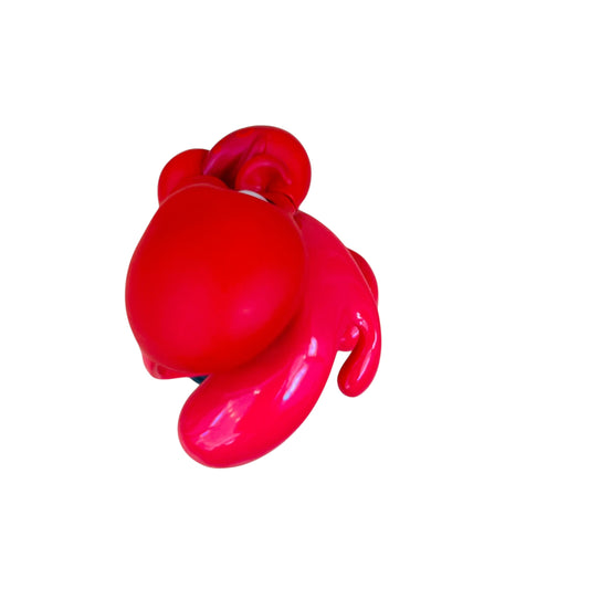 Red balloon dog toy on a white background