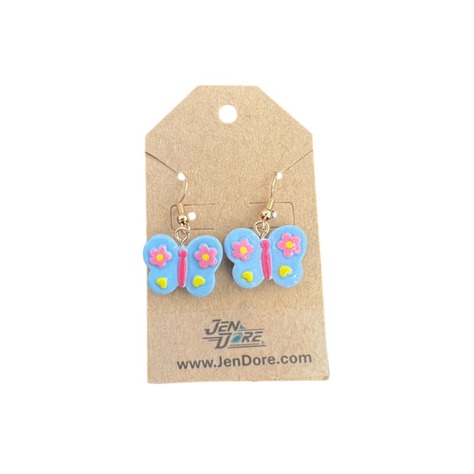 Butterfly-shaped earrings on a JenDore branded card against a white background