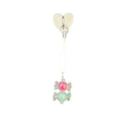 Heart-shaped clip with colorful gemstone pendant on a white background
