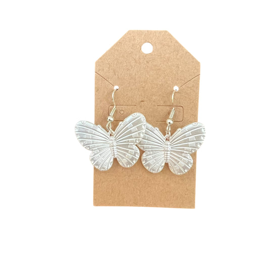 JenDore Butterfly earrings on a brown cardboard backing with a white background