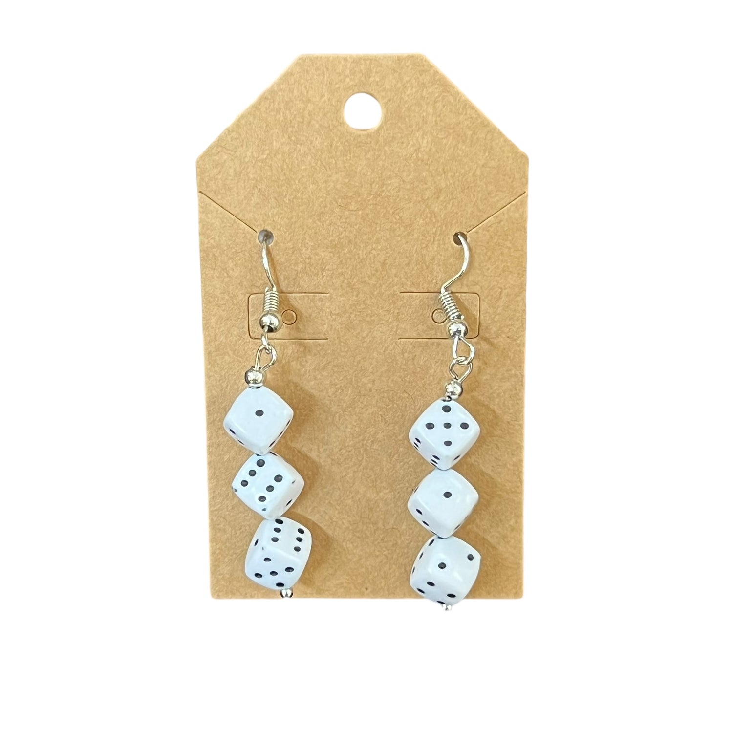 Pair of dice-shaped earrings on a cardboard backing