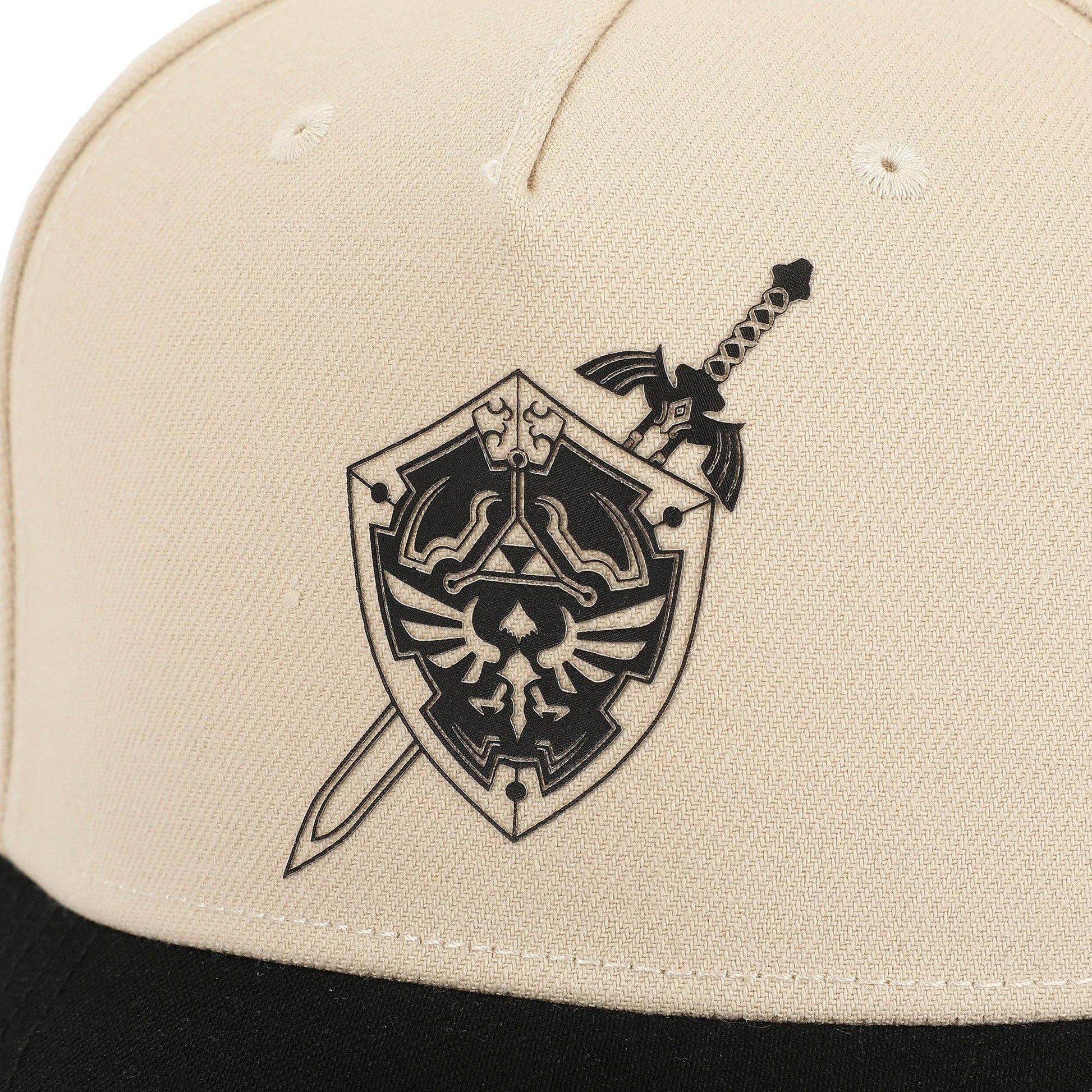 Beige cap with black emblem featuring a shield and sword design.