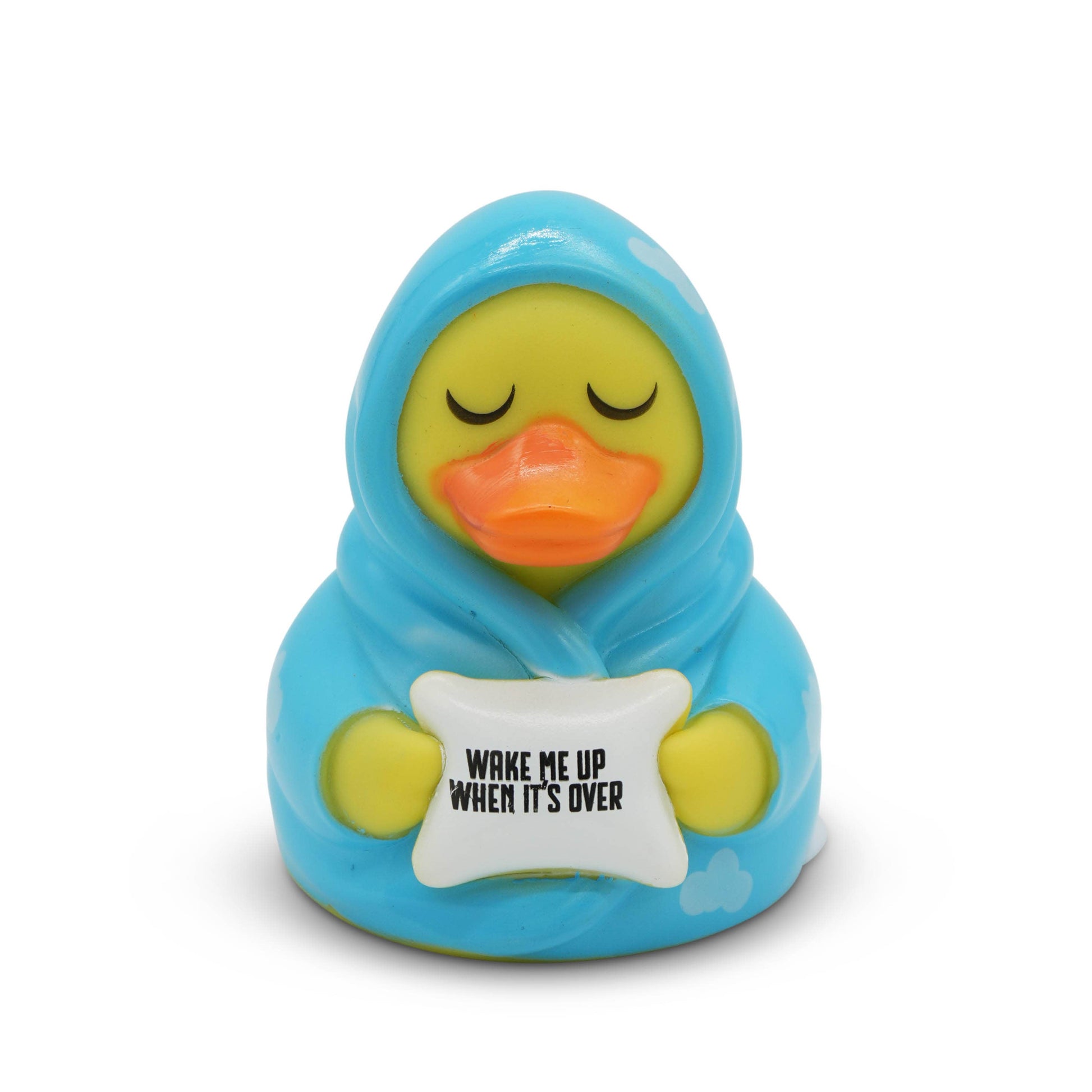 Toy duck wrapped in blue blanket with 'Wake Me Up When It's Over' sign on white background