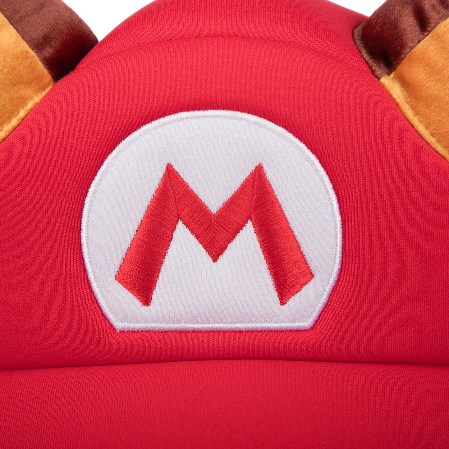Close-up of a red hat with a white 'M' logo on a character from a video game.