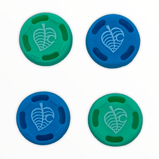 Blue and green leaf silicone thumb grip caps compatible with Nintendo Switch controllers by JenDore.